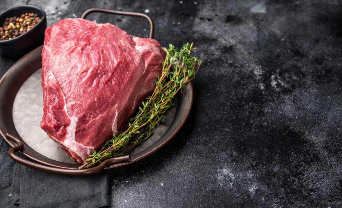 Raw Wild Boar meat, fresh Game Meat. black background. top view