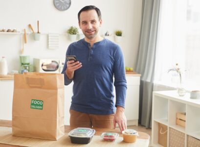 Smiling Man Enjoying Food Delivery Service