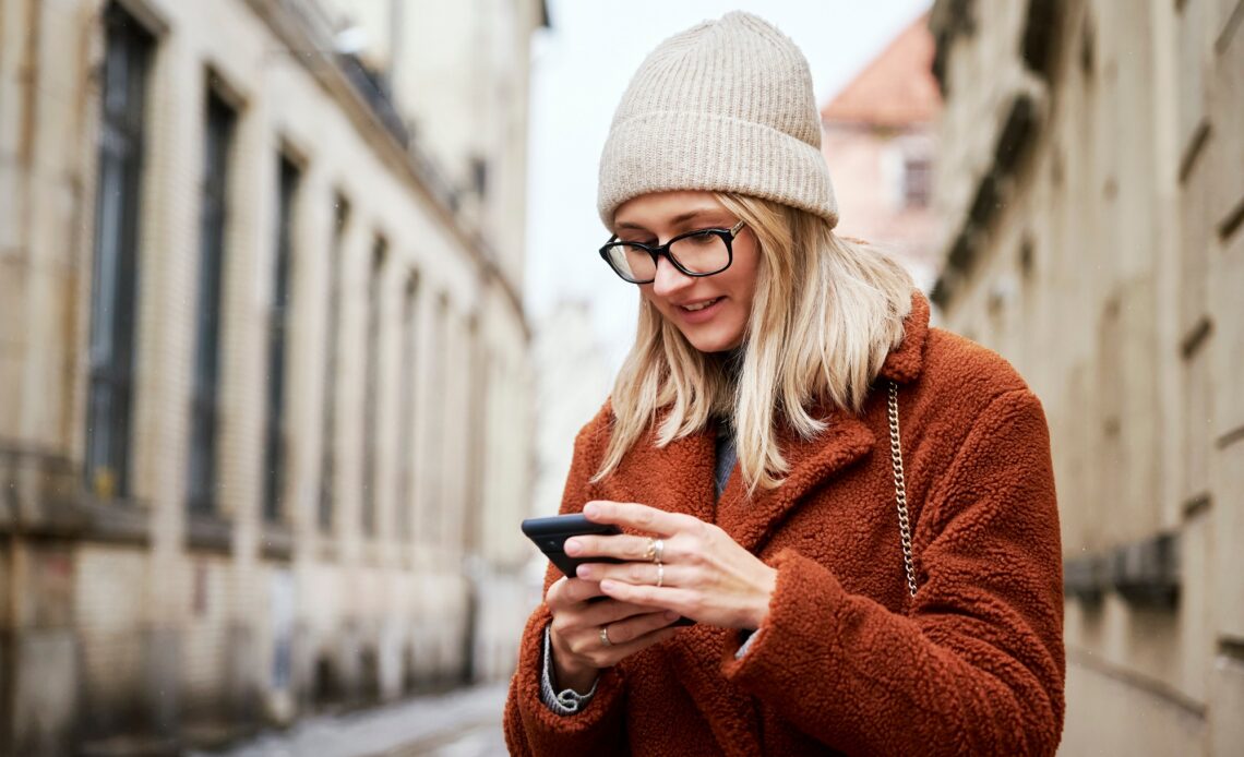 Woman using smartphone at city street