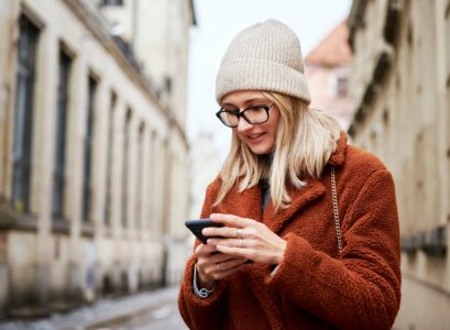 Woman using smartphone at city street