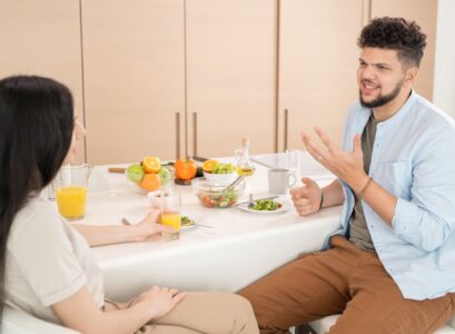 Young couple talking by breakfast