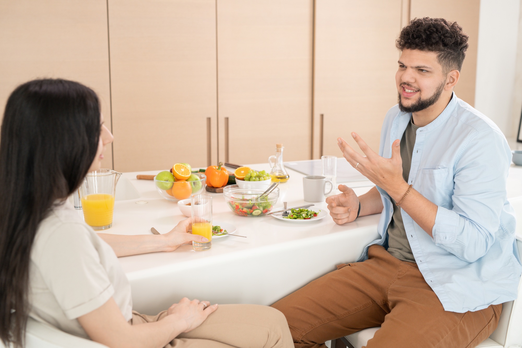 Young couple talking by breakfast